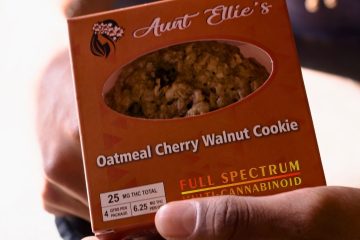 Oatmeal Cherry Walnut Aunt Ellie's Luis holding an Oatmeal Cherry Walnut Cookie. tucson edibles