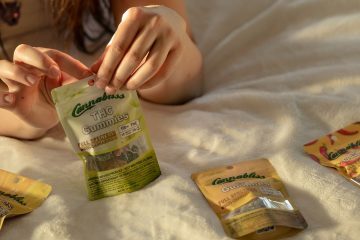 Embrace Pure Bliss Paulette on the bed with all the gummies. Cannabliss THC Gummies. Halo Infusions. Full Spectrum. Best edibles in Arizona. tucson edibles