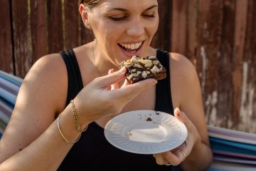 Indulge in Delight Dani eating a gluten free brownie with a smile. Aunt Ellie's. Halo Infusions. best edibles in arizona. tucson edibles